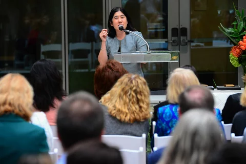 Presenter talking to a group of people outdoors